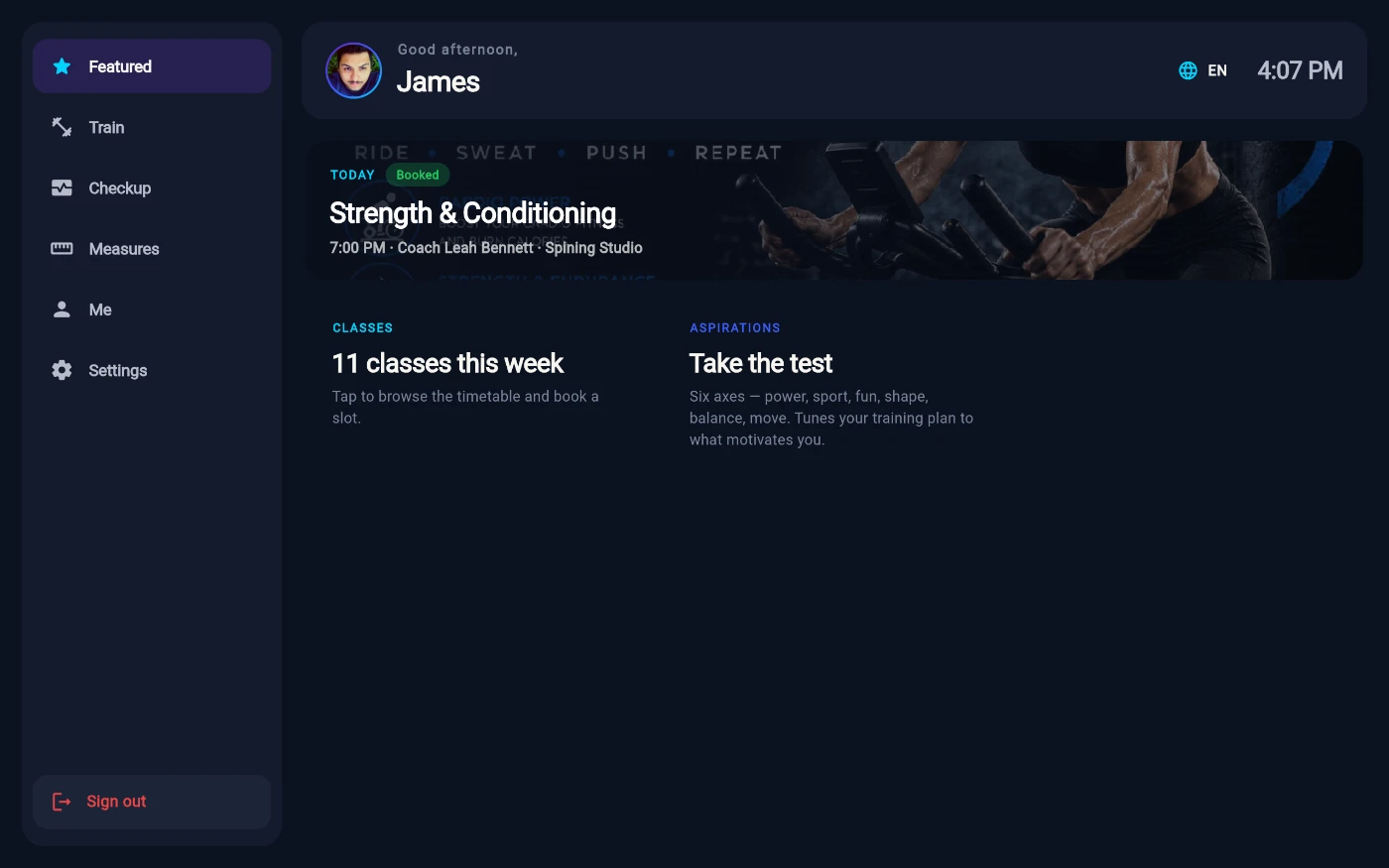 The Featured tab of a signed-in kiosk session: the left rail with Featured, Train, Checkup, Measures, Me and Settings, a Good afternoon James header, a next-class hero for a booked Strength and Conditioning class at 7:00 PM, and stat tiles for 11 classes this week and the aspirations test.
