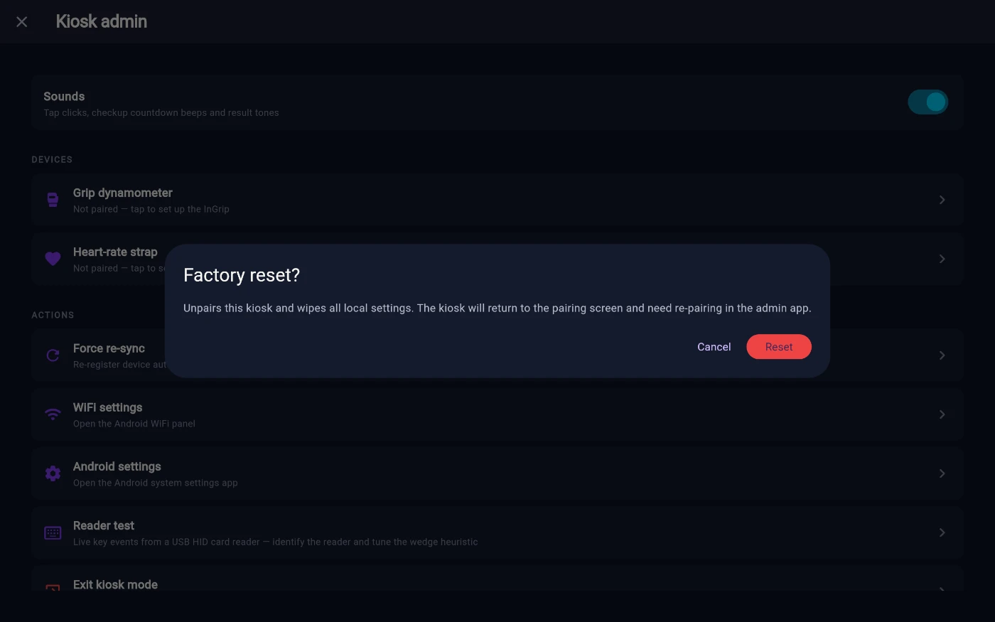 The Factory reset? confirmation dialog over the staff panel, reading Unpairs this kiosk and wipes all local settings. The kiosk will return to the pairing screen and need re-pairing in the admin app, with Cancel and a red Reset button.