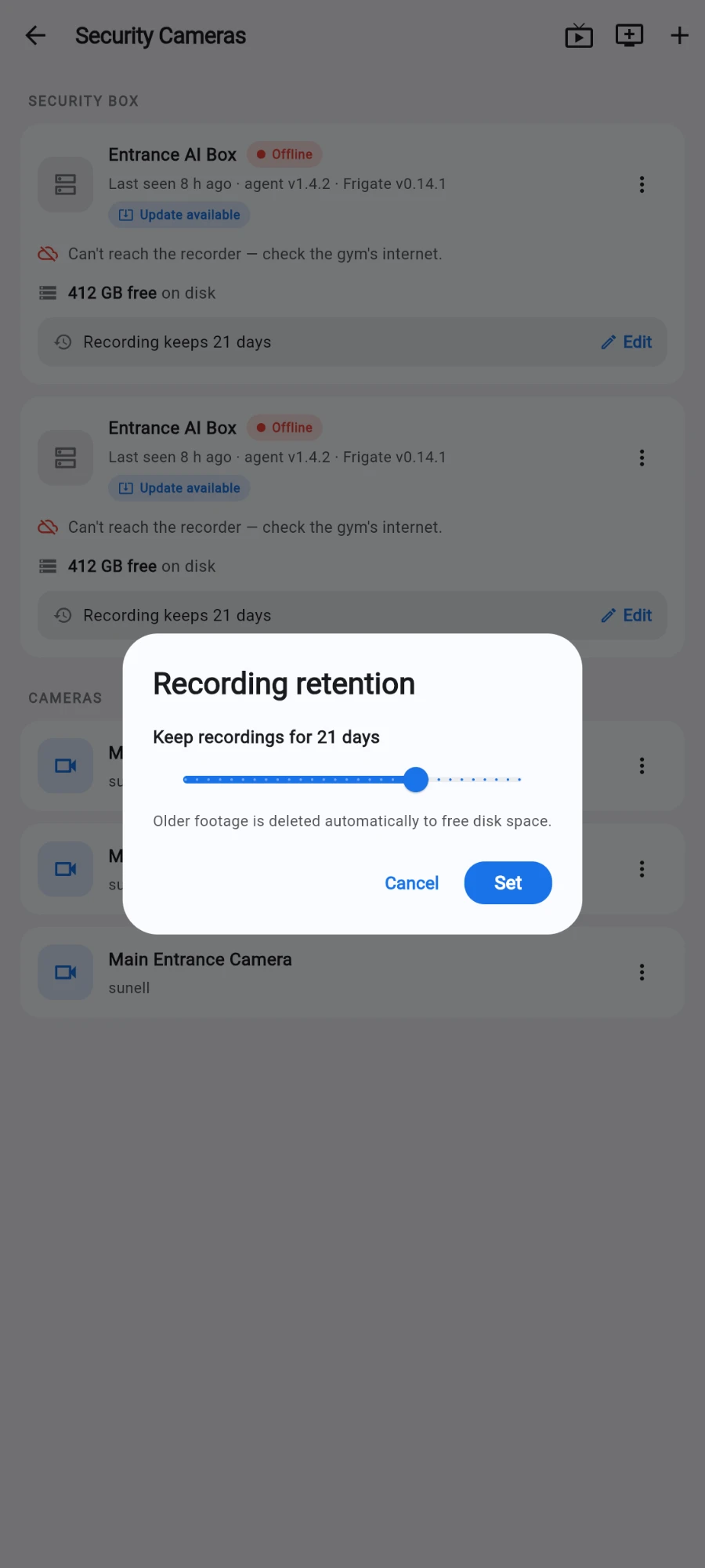 The Recording retention dialog on the Security Cameras screen, reading Keep recordings for 21 days above a slider, with the note Older footage is deleted automatically to free disk space and Cancel / Set buttons; behind it the Entrance AI Box cards show Recording keeps 21 days with an Edit link